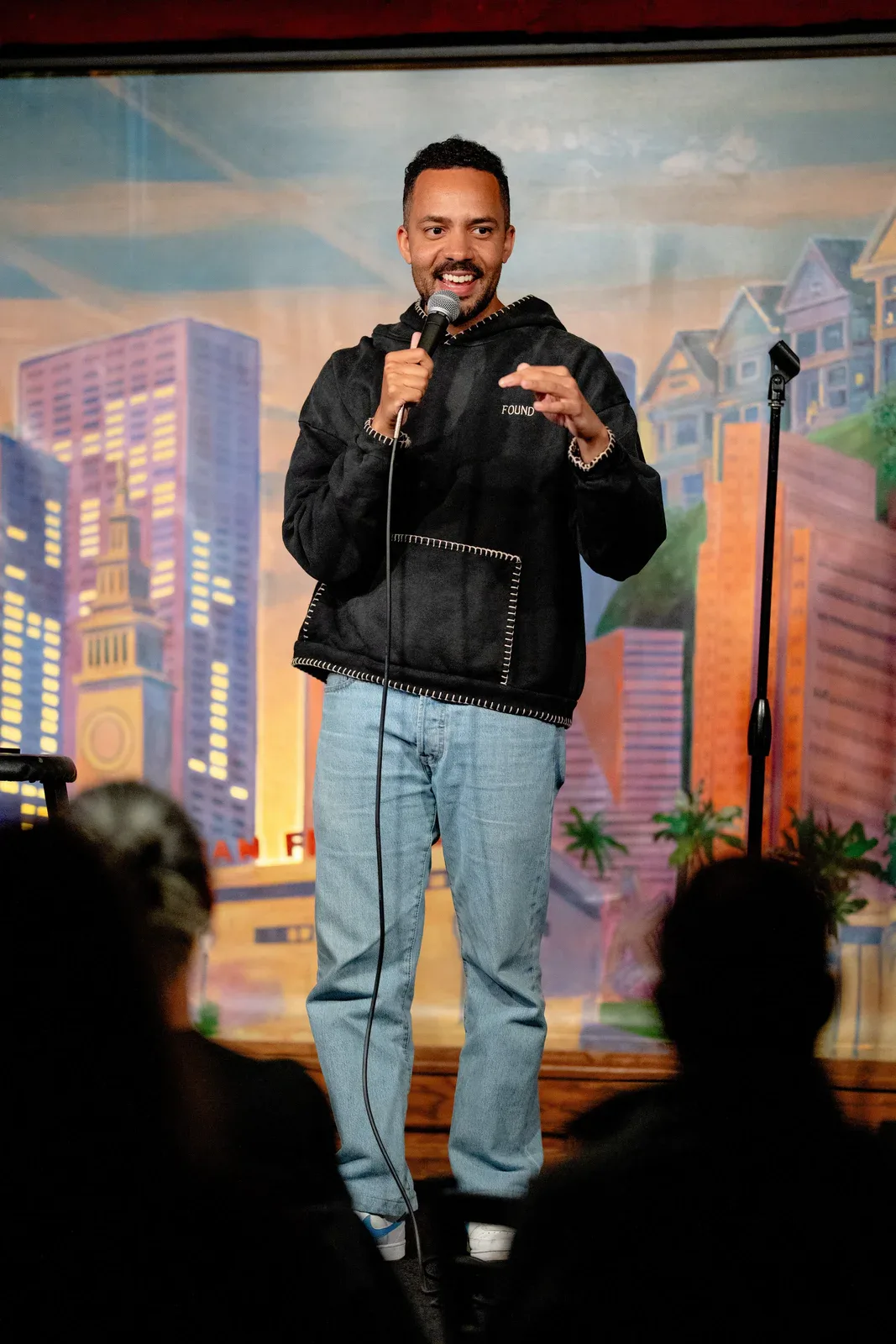 James Mwaura performing stand-up comedy on stage